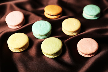 Obraz na płótnie Canvas Gentle colorful macaroons on color fabric background