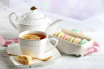 Colorful macaroons with cup of tea