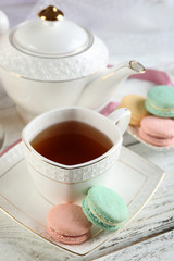 Colorful macaroons with cup of tea