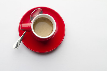 Red espresso cup on a white table
