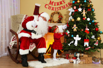Santa Claus giving  present to  little cute girl near