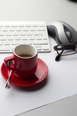 Red espresso cup on a white table