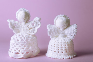 Knitted Christmas angels on color background
