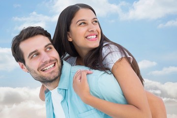 Casual man giving pretty girlfriend piggy back