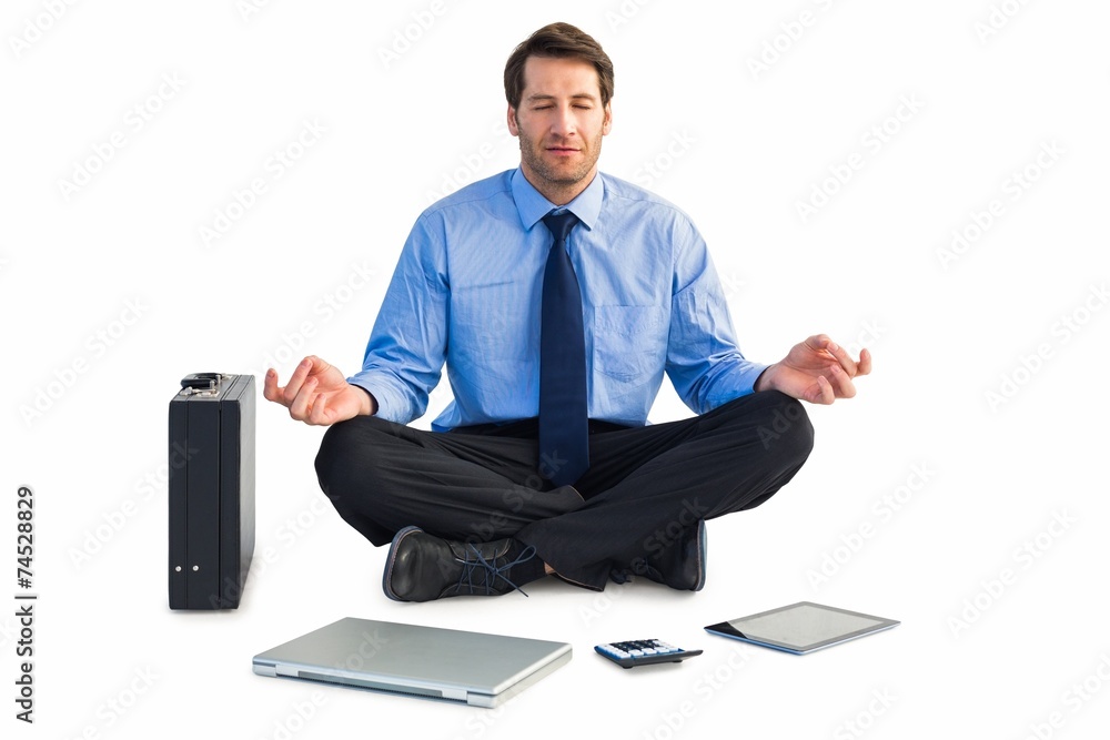 Poster man sitting in lotus pose with laptop, tablet and suitcase