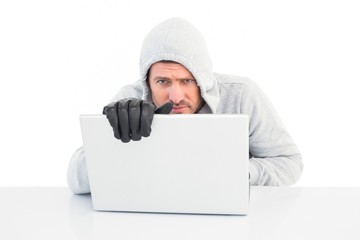 Hacker using laptop to steal identity