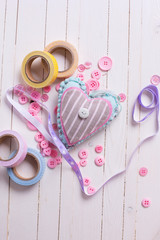 Heart and scrapbooking elements on wooden background