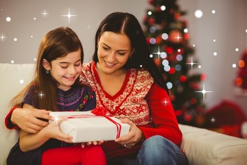 Mother and daughter holding christmas gift