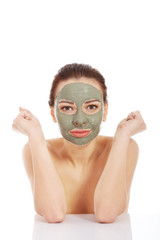 Woman in green face mask sitting at the desk