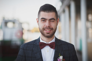 Groom with a red butterfly