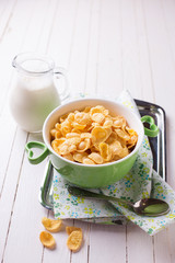 Cornflakes in bowl on table