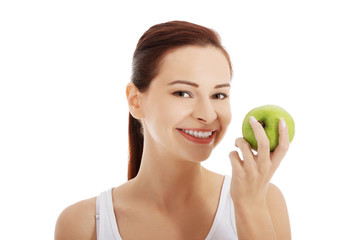Portrait of brunette woman holding an apple
