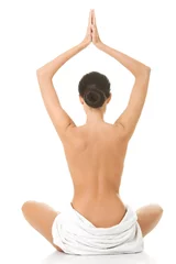 Poster Back view of a woman in towel practising yoga © Piotr Marcinski