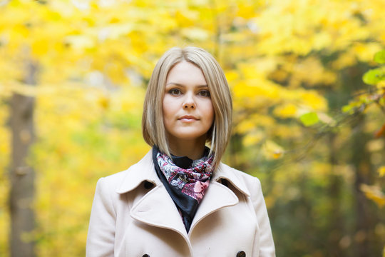 Serious Young Woman In Autumn Forest