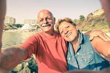 Senior happy couple taking selfie at Blue Grotto resort in Malta