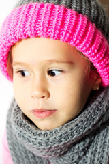 Little girl in winter hat with gloves and scarf.