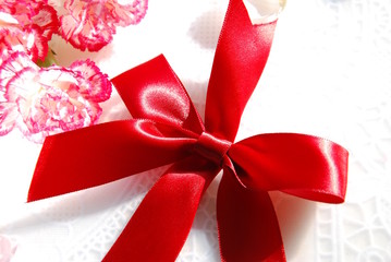 red ribbon with carnation flowers