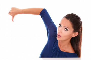 Fototapeta premium Attractive girl in blue shirt with thumb down