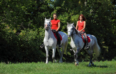 Two young women on horseback
