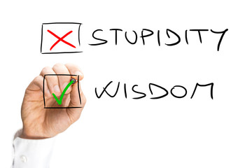 Human Hand Marking X on Stupidity and Check on Wisdom
