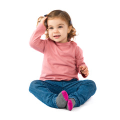 Little girl sitting over white background