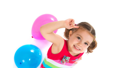 Kid playing with balloons over white background
