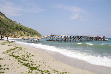 Broken bridge on beach