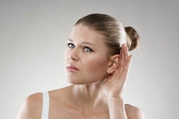 Deafness. Young woman having hearing problems