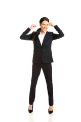 Full length angry businesswoman making fists