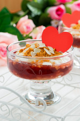 dessert with berry jam and cream for Valentine's Day, vertical