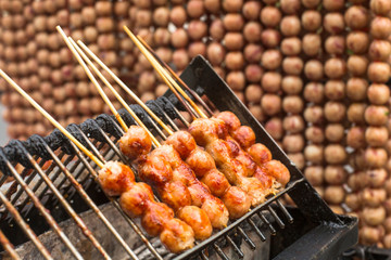 Traditional Thai style grilled meat roll. Asian street food.