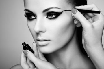 Makeup artist applies eye shadow