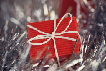 Close up of red gift box in abstract christmas decoration