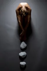 Gordijnen Top view of sensual nude woman and stones © Wisky