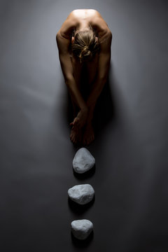 Fototapeta Top view of sensual nude woman and stones