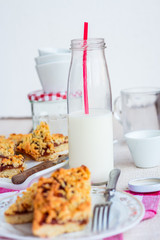pie pastry with apple jam and milk in a glass bottle