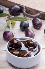 black olive on a white wodden board