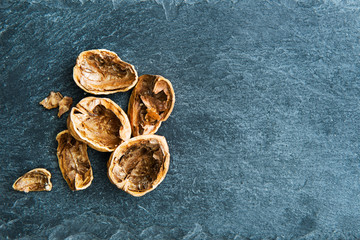 Closeup on walnut shells on stone substrate