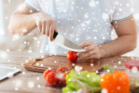 close up of man cutting vegetables with knife