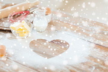 Fototapeta na wymiar heart of flour on wooden table at home