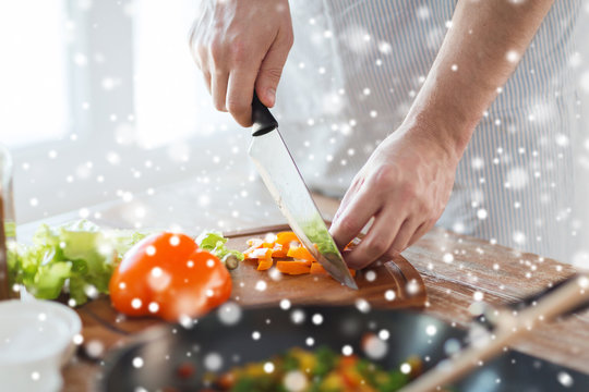 close up of man cutting vegetables with knife