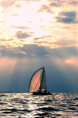 Sports yacht in the sea at sunset.