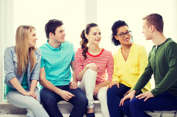 five smiling teenagers having fun at home