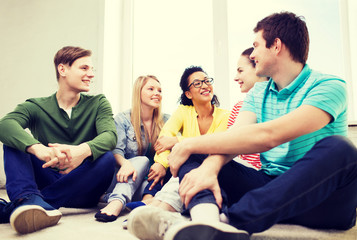 five smiling teenagers having fun at home