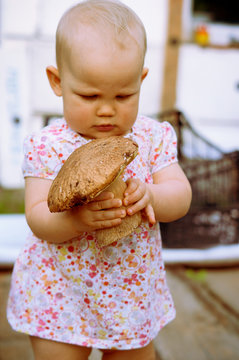 One Year Old Baby Girl  With Mushroom Boletus