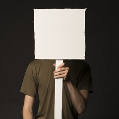 Faceless person holding a blank sign - 74551641