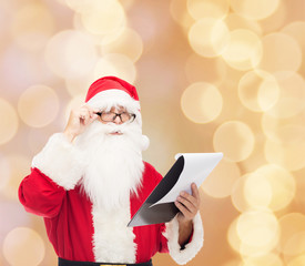 man in costume of santa claus with notepad