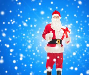 man in costume of santa claus with gift box