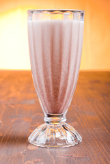chocolate banana cocktail on brown board at sunset