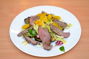 Roasted meat and vegetables on white plate